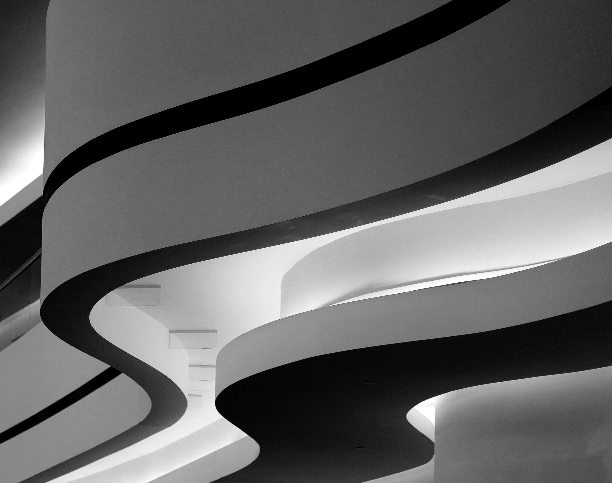 closeup greyscale shot of a building with curvy twists in berlin, germany