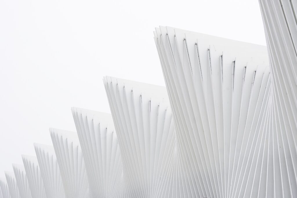 horizontal shot abstract buildings with white metallic ribs and glass windows
